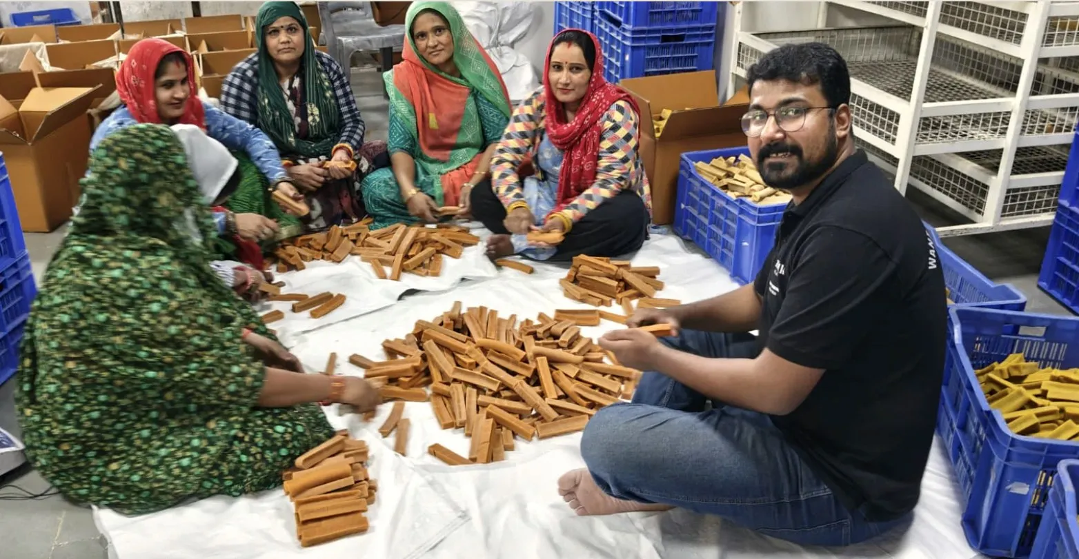 A TrueSource Global team member checking a batch of yak cheese chews with a producer partner's team