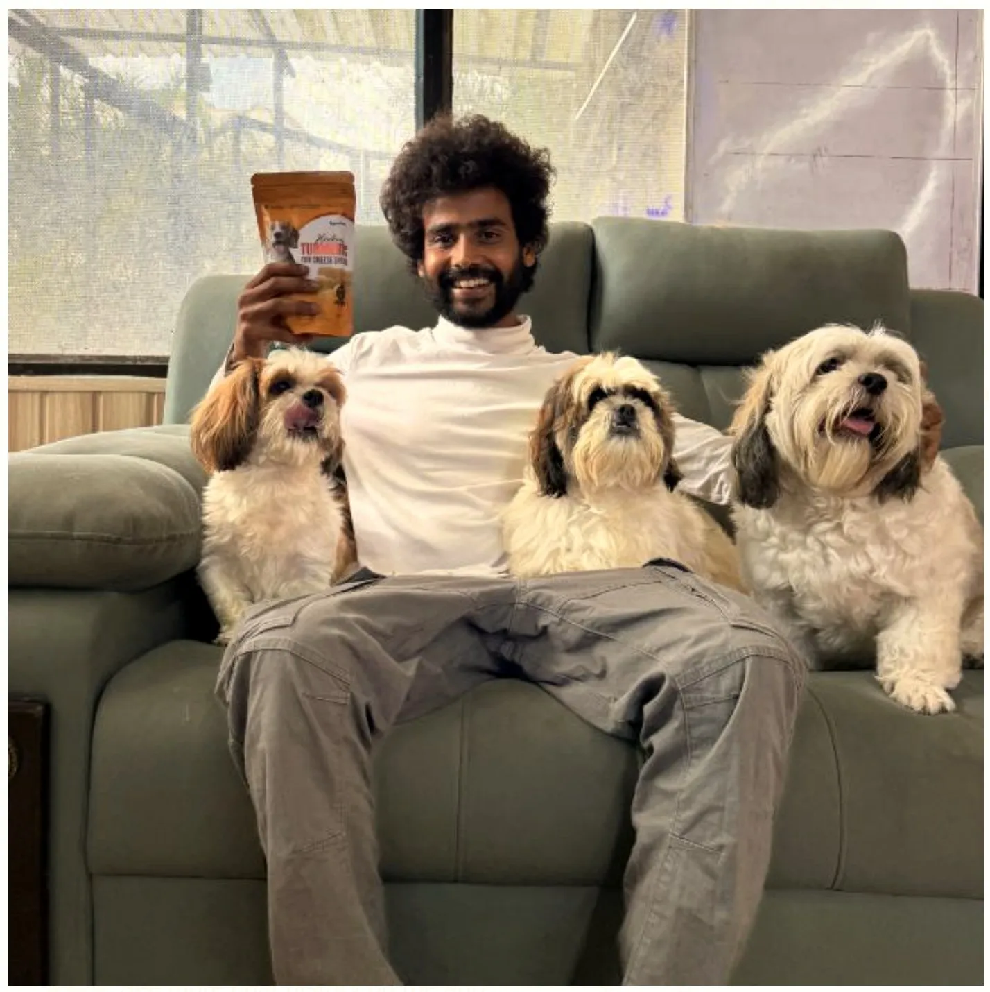 Divyanshu, founder, testing a pet product with three dogs