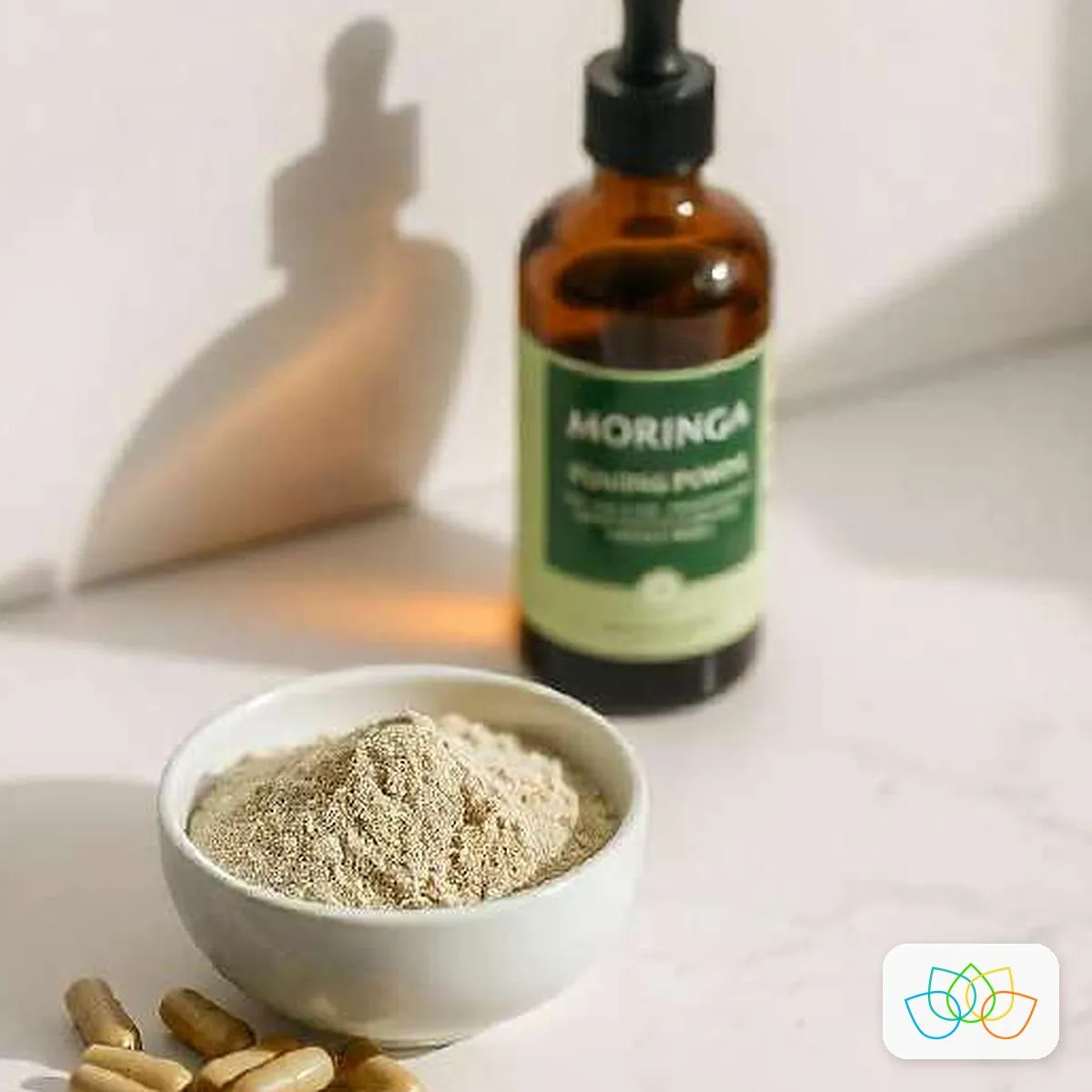 Moringa leaf powder with a bottle of moringa extract and capsules